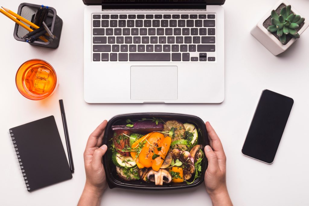 Takeaway food, computer and a smartphone.