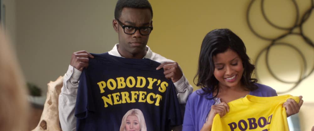 Still from the TV show “The Good Place.” Characters Chidi and Tahani hold up t-shirts that say “Pobody’s Nerfect.”