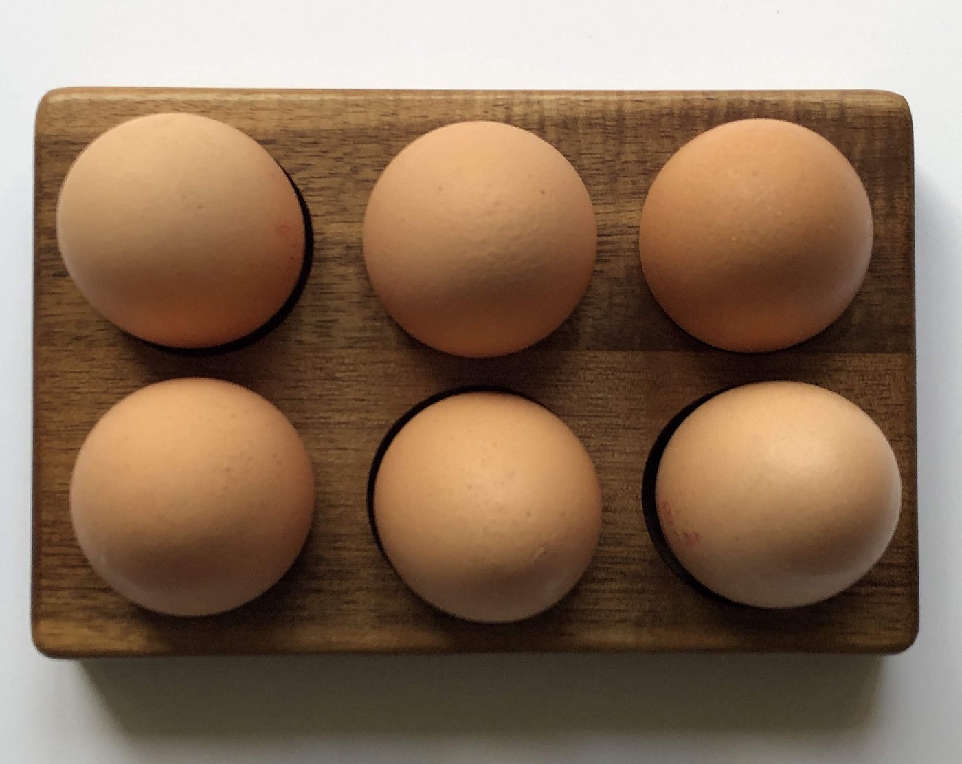 half a dozen brown eggs in a carton