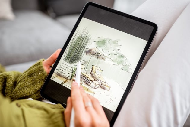 Woman drawing landscape design on a digital tablet