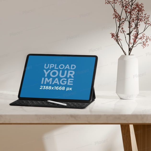 iPad Pro Mockup Featuring a Marble Desk and a Flower Vase