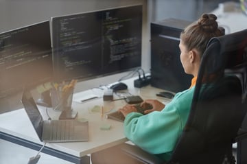 Woman working with security code on computer