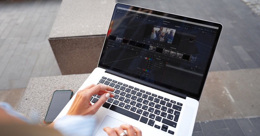 Macbook user checking DaVinci Resolve 17 system requirements ( image source: https://elements.envato.com/close-up-of-female-hands-typing-on-computer-keyboa-V9ML5SE )