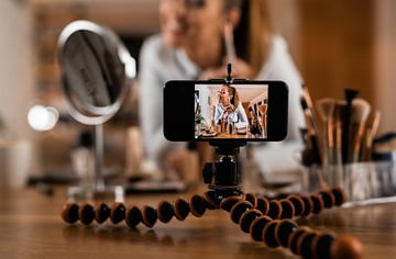 Close-up of make-up artist recording video tutorial about beauty products