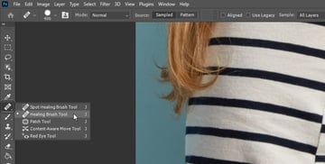 Remove a tattoo from a photo: take the healing brush tool.