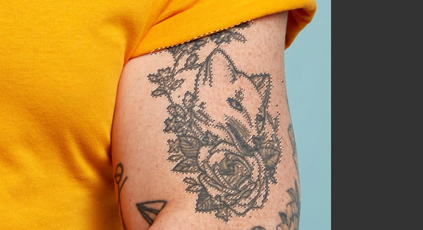 Remove a tattoo from a photo: selection expanded.